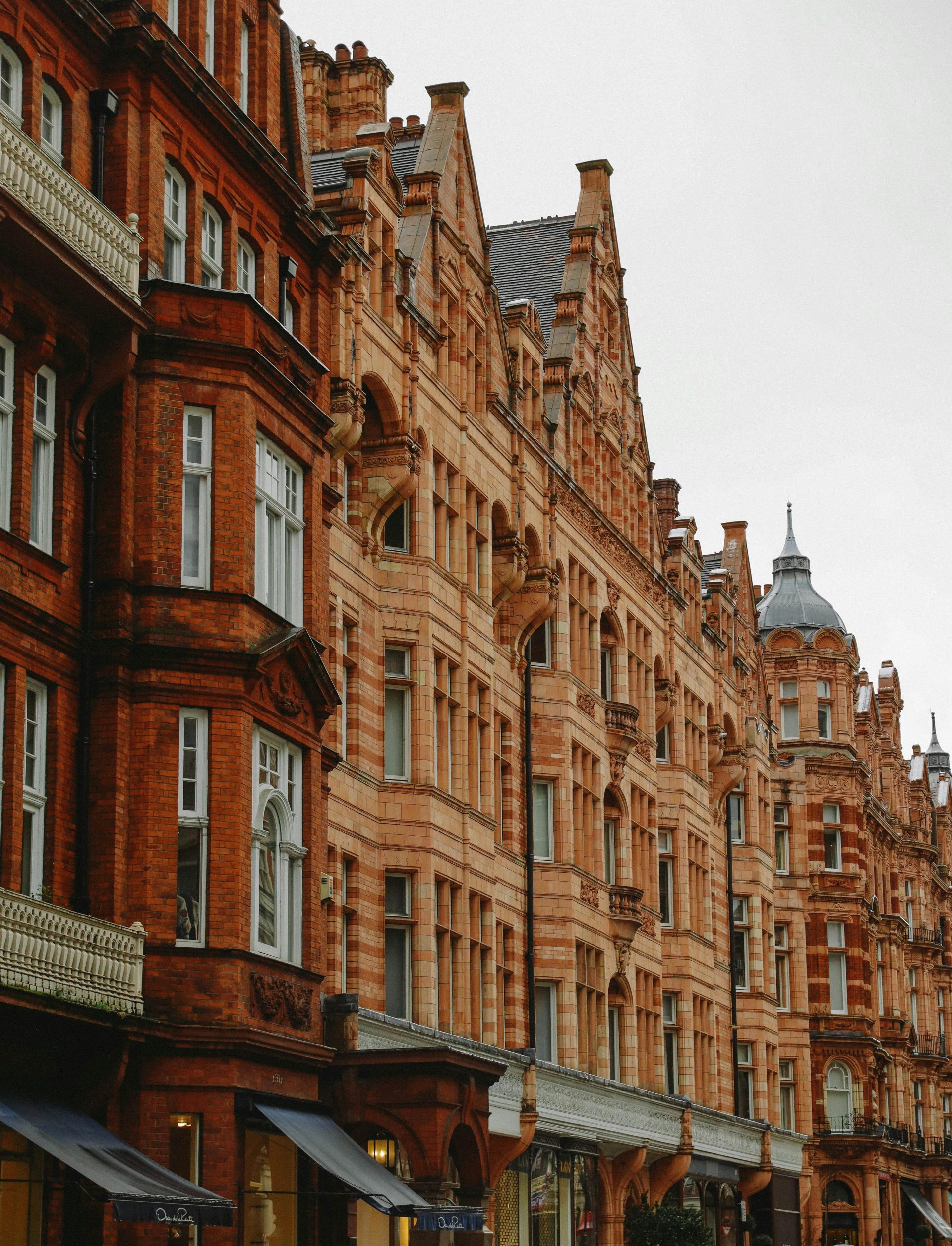 A striking view of historic Gothic-style brick buildings in London, showcasing architectural elegance.