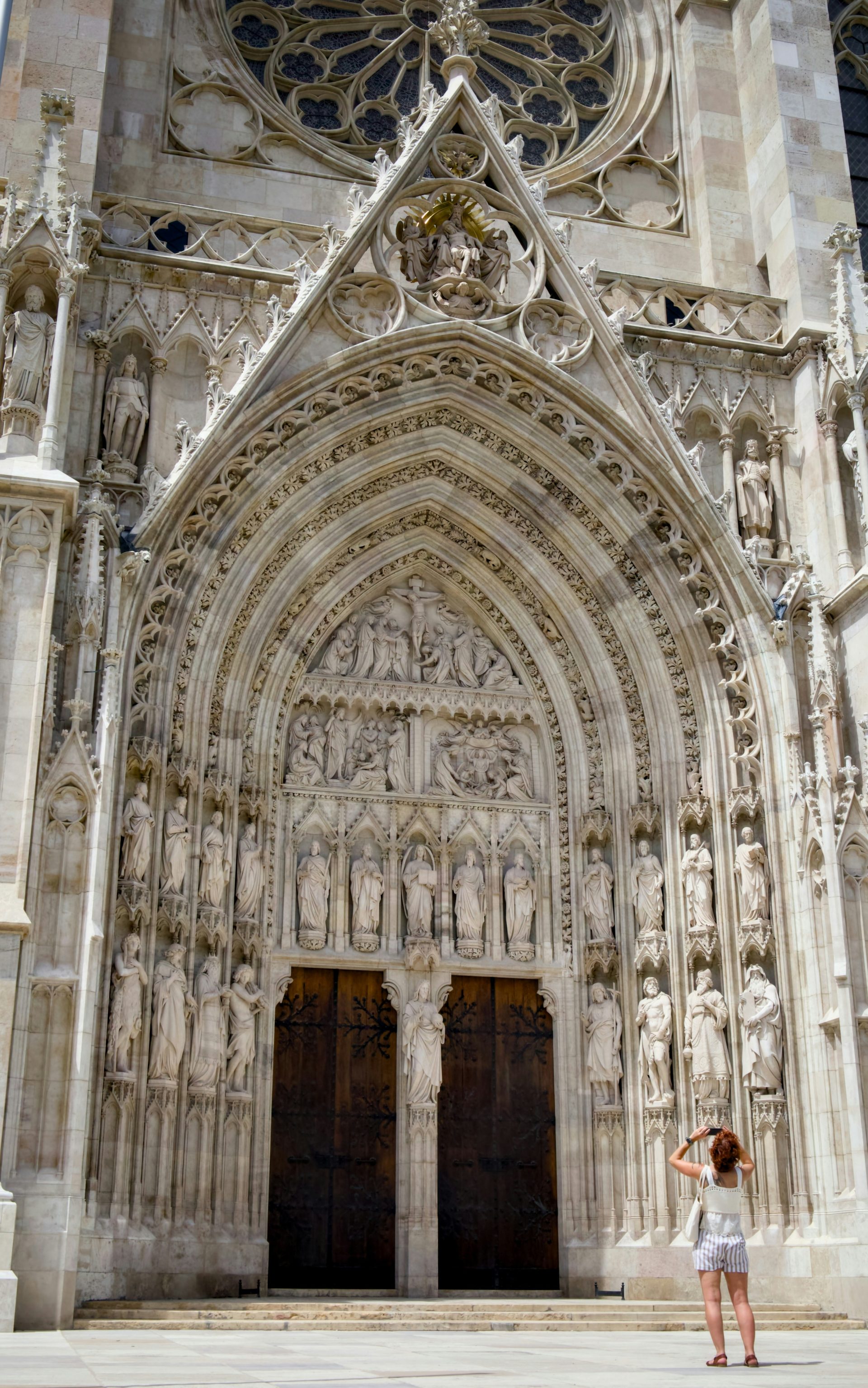 A woman standing in front of a large cathedral
